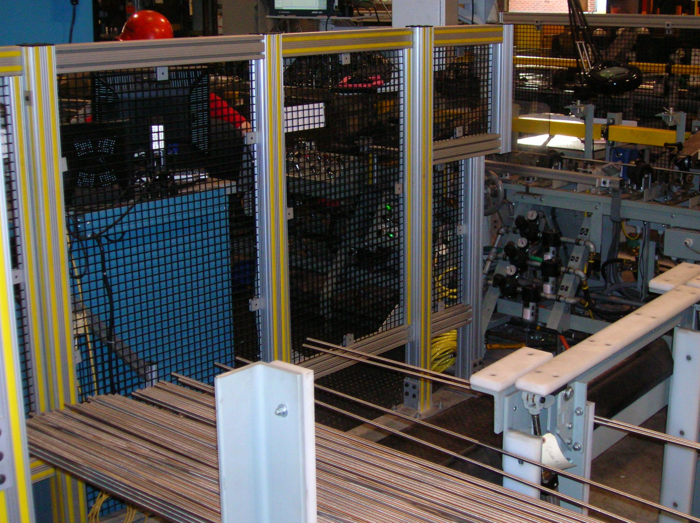 T-slotted 80_20 aluminum cage surrounding production controls